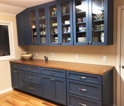 Rice Furniture & Design Center | custom blue dining room cabinets with glass doors and silver handles