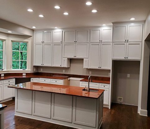 Rice Furniture & Design Center | custom designed white wooden cabinets and drawers in a new kitchen