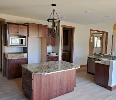 Rice Furniture & Design Center | custom built cabinets in dark wood for kitchen to match wood elements in the home